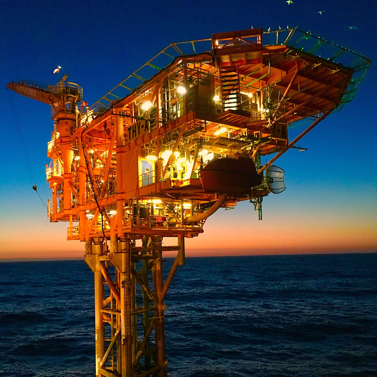 Image of Thylacine-offshore platform, Otway, in the early morning with calm sea and magnificent crimson sunrise in background